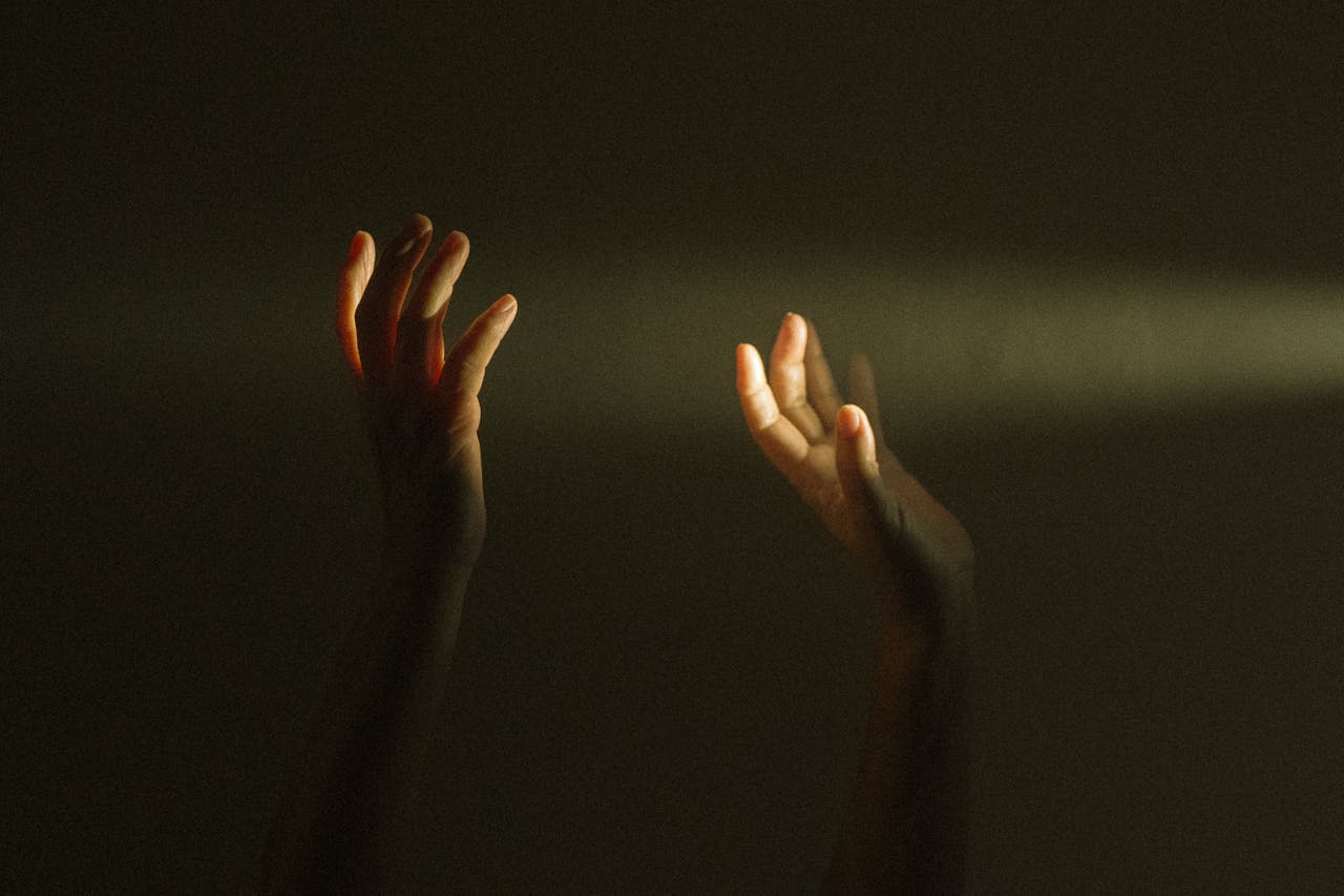 our-services-03 Expressive hands reaching towards a ray of light symbolize hope and mental resilience.